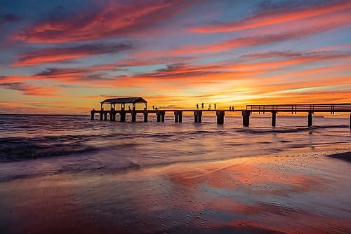 Vivid sunrise clouds silhouette Waimea Pier with Niihau Island in distance in Kauai-Hawaii-USA Coastal Print